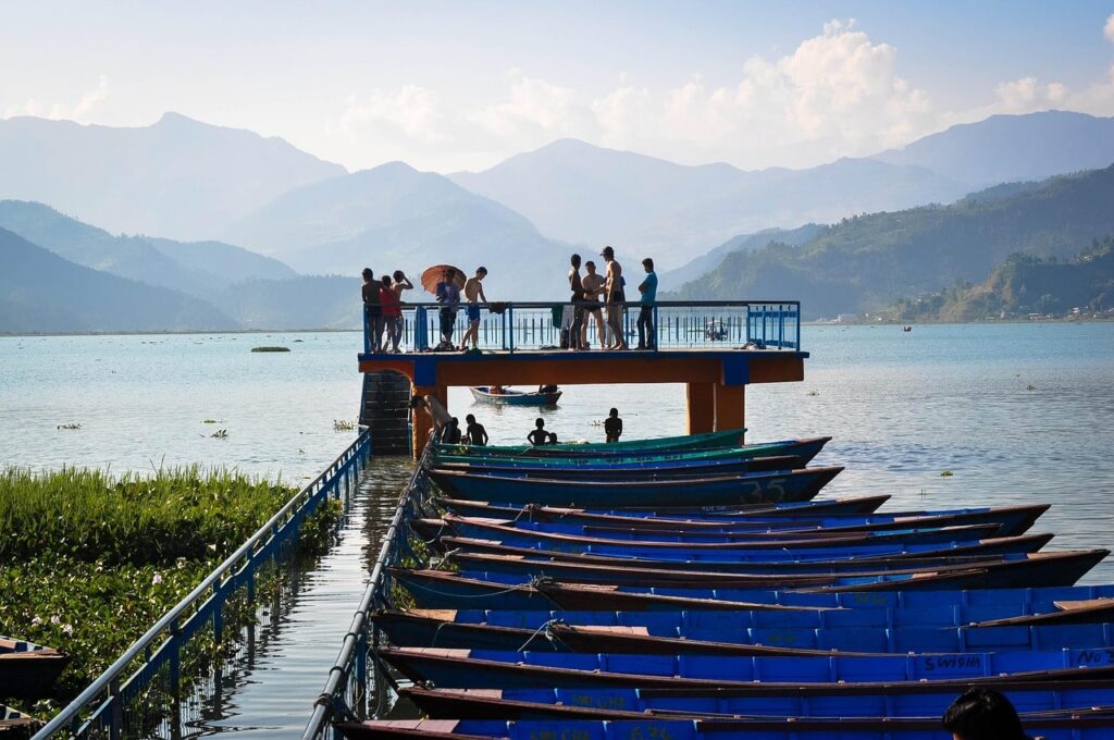 Pokahara-phewa-lake-min Tranquil waters of Phewa Lake reflecting the Annapurna range, with colorful boats gently floating—Pokhara’s serene escape into nature’s beauty.
