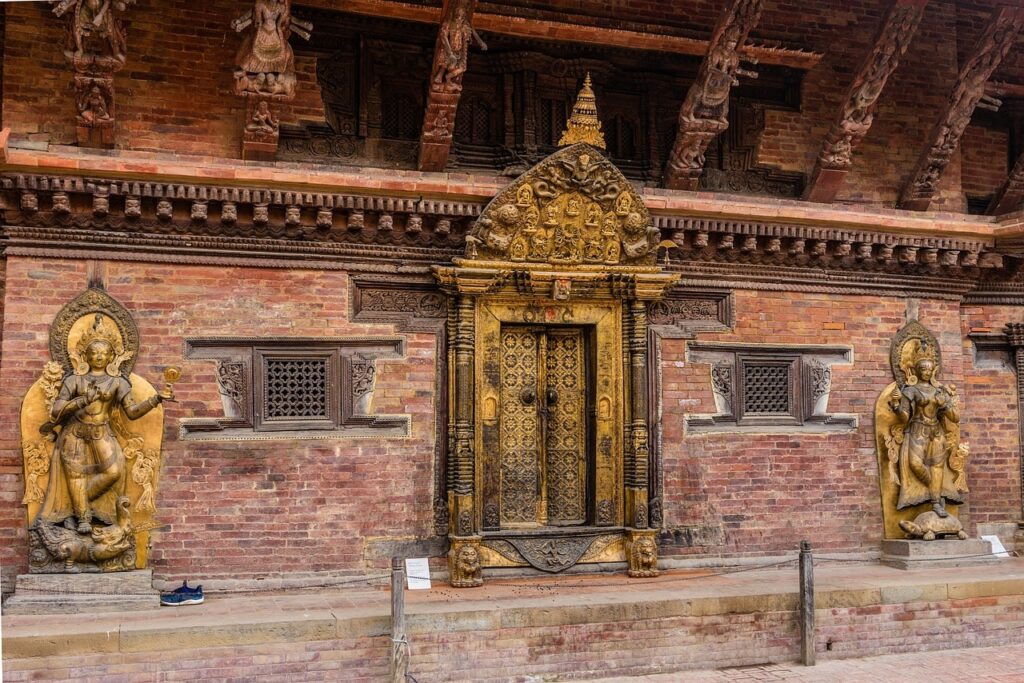 Kathmandu-durbar-sqaure-temple-entry-min The ornate entry gate to one of the historic temples in Kathmandu Durbar Square reflects the exquisite craftsmanship of the Malla era, welcoming visitors into Nepal’s royal and cultural heart.