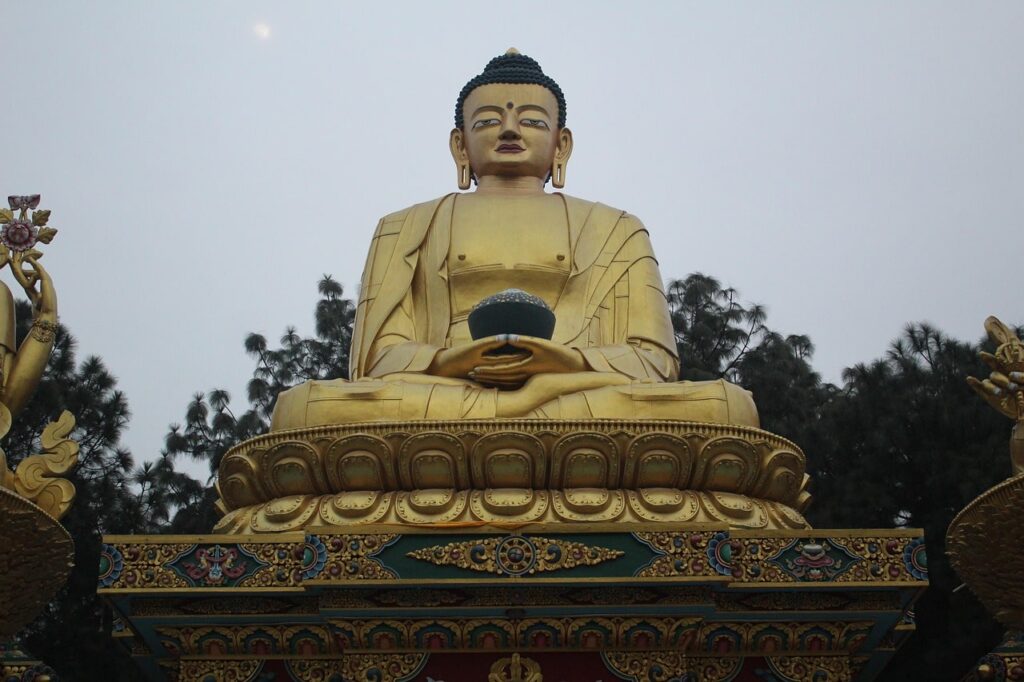 buddha-swyambhunath-min The majestic Buddha statue at Swayambhunath Temple sits in quiet grace, overlooking the Kathmandu Valley as a symbol of wisdom, compassion, and enlightenment.