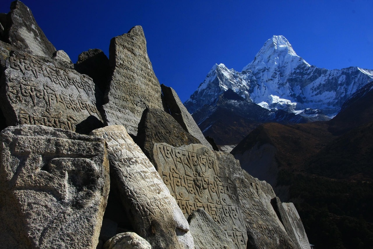Mani stones are crafted and placed near the trials of the mountains in Nepal.