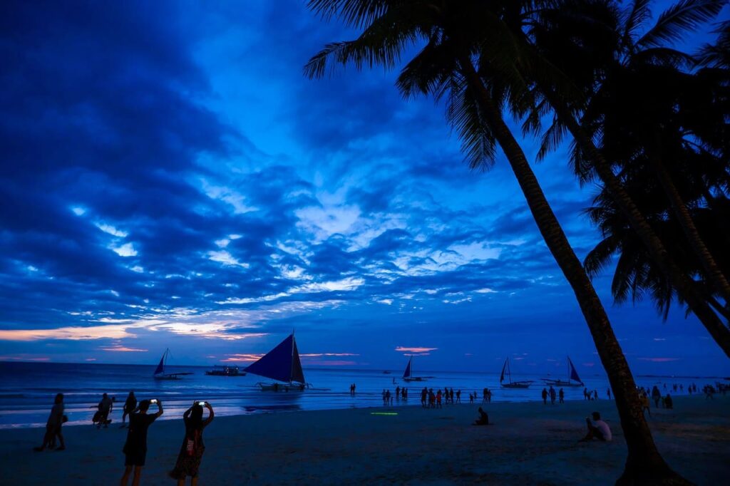 Pristine white sand beaches and crystal-clear turquoise waters of Boracay, the ultimate tropical paradise in the Philippines.