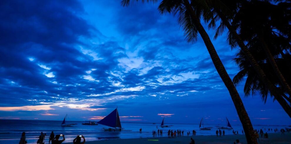 Pristine white sand beaches and crystal-clear turquoise waters of Boracay, the ultimate tropical paradise in the Philippines.