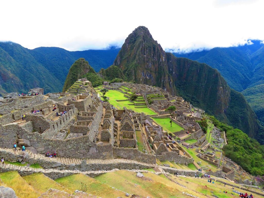 machu-picchu Machu Picchu in Peru, ancient Incan citadel surrounded by Andes mountains and lush greenery.