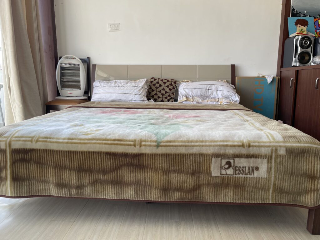 Cozy bedroom at Peaceful Residency apartment in Tarkeshwar, Kathmandu with modern furnishings.