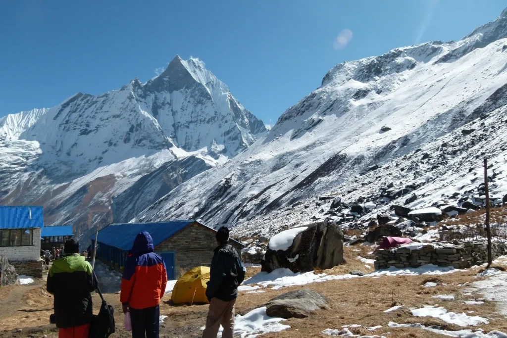 Stunning mountain landscape viewed during a trek, with snow-capped peaks, green valleys, and clear blue skies