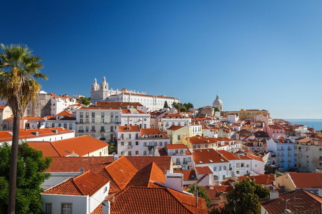 Scenic view of a charming city in Portugal with colorful buildings, historic architecture, and sunlit streets.