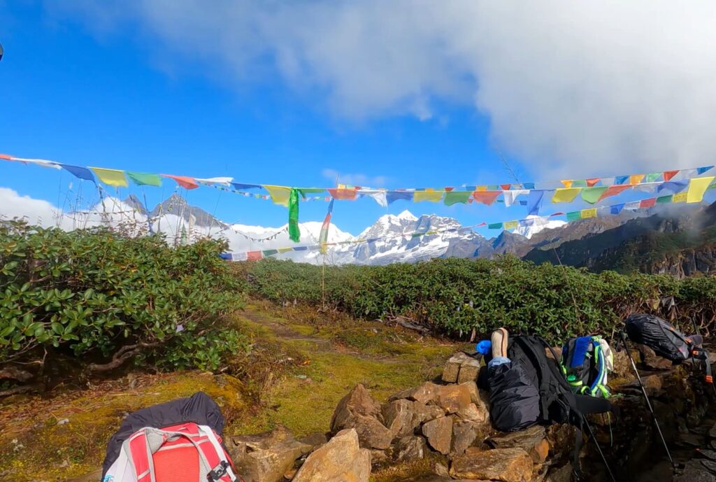 Distant view of Mount Makalu rising above the Himalayan landscape, partially covered in snow and clouds