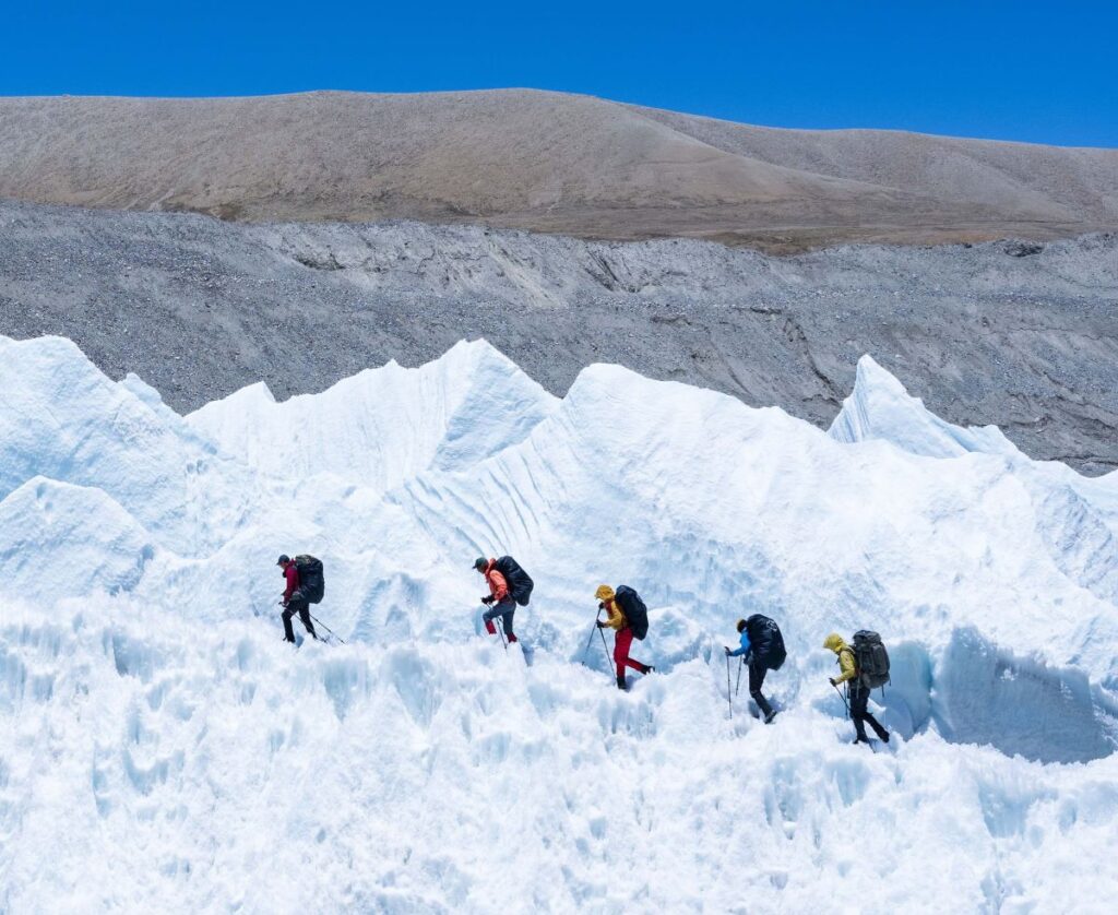 climbers walking on snow of manaslu peak